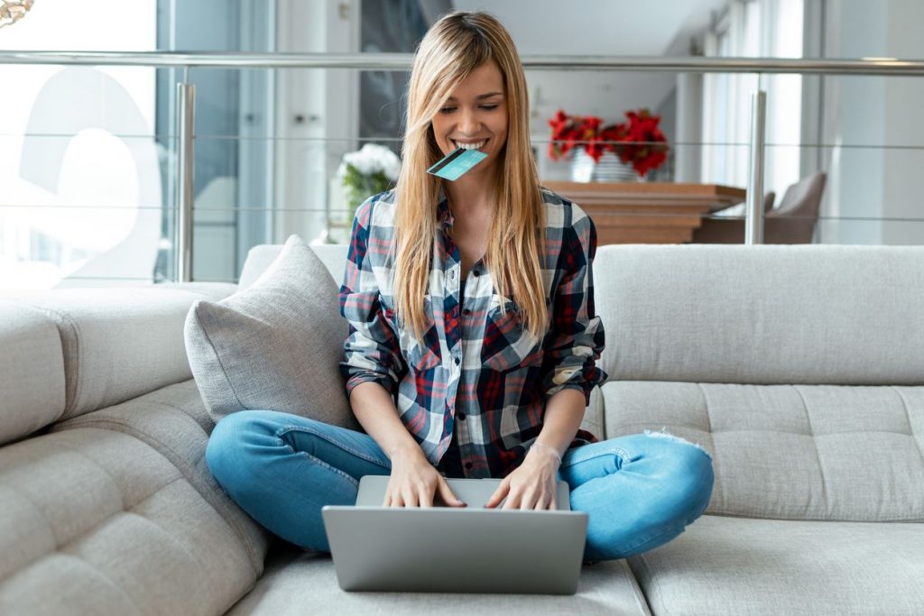 mujer con tarjeta de crédito en la boca